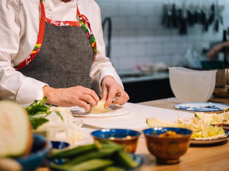 Woman rolling rice paper rolls